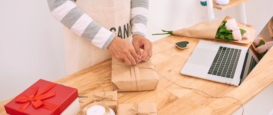 Christmas retail man wrapping present XL